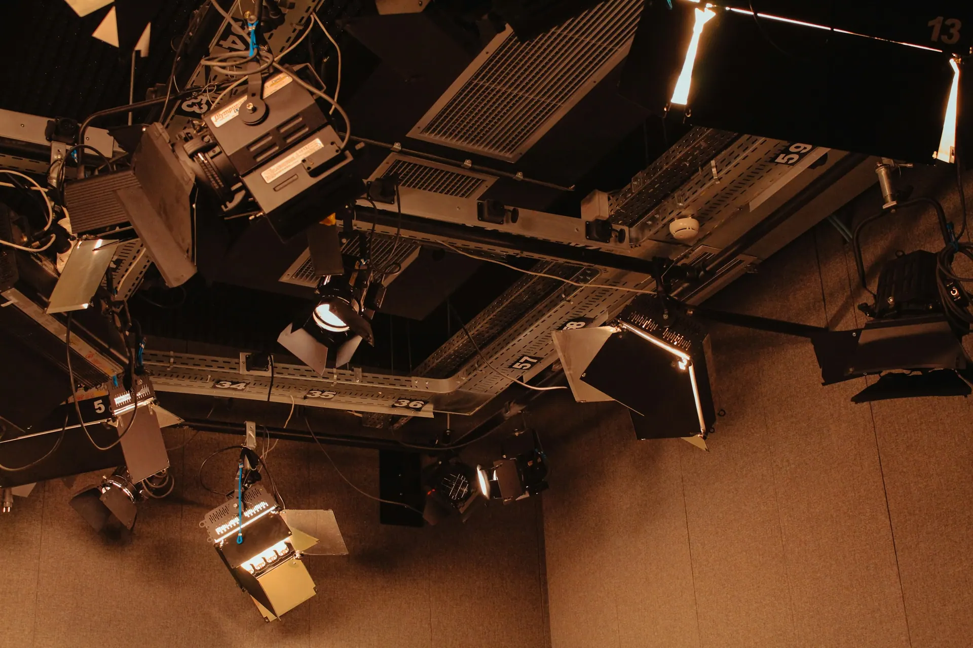 Interior of a photography studio showing lighting equipment and an open shooting area.