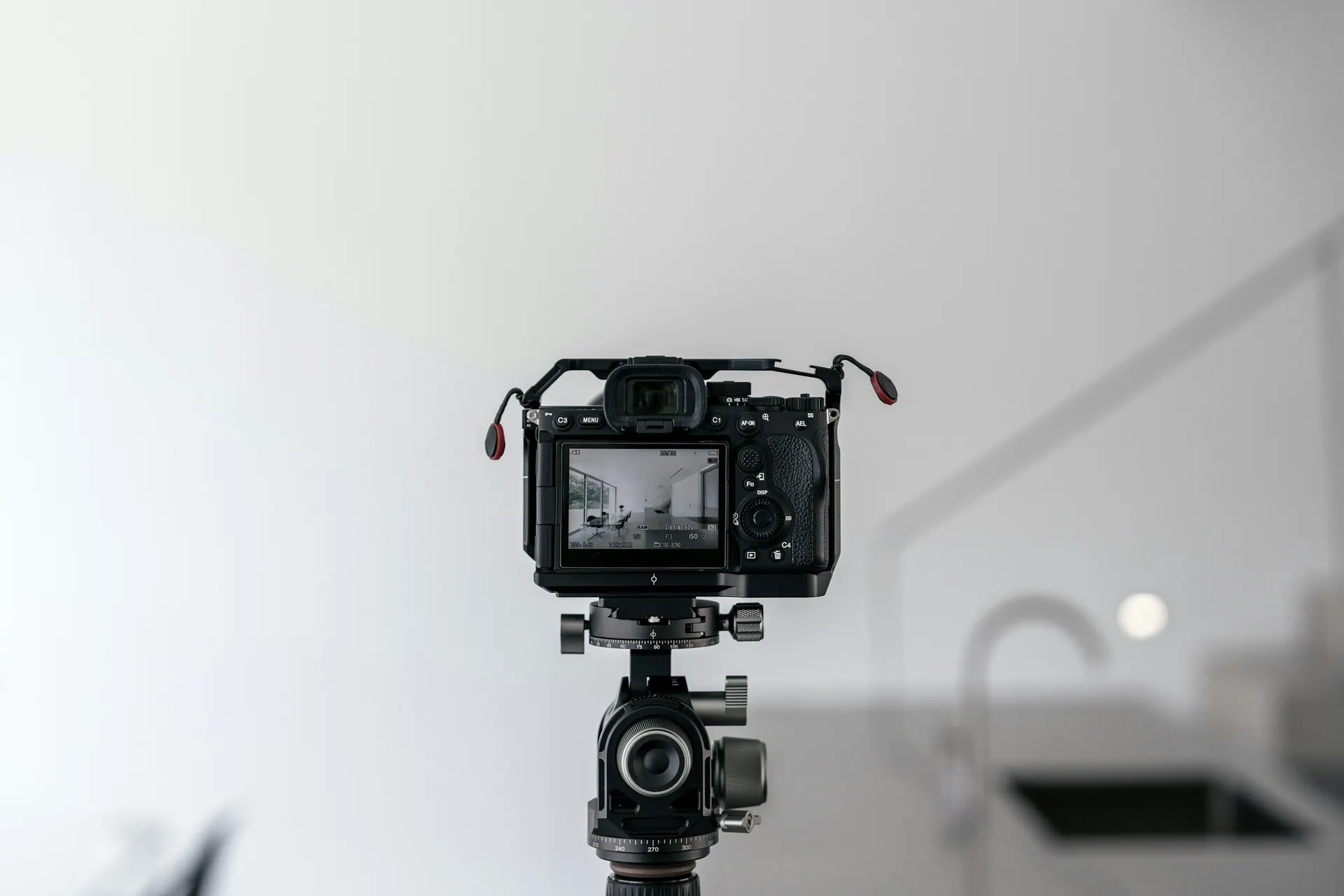 A tabletop product shoot in progress with a camera mounted on a tripod above the set.