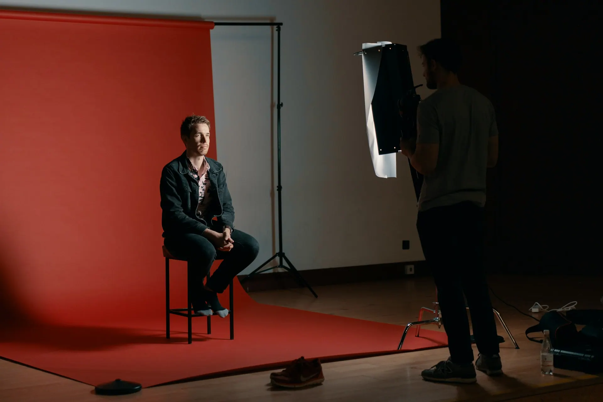 A corporate headshot setup with a neutral backdrop and balanced studio lighting.
