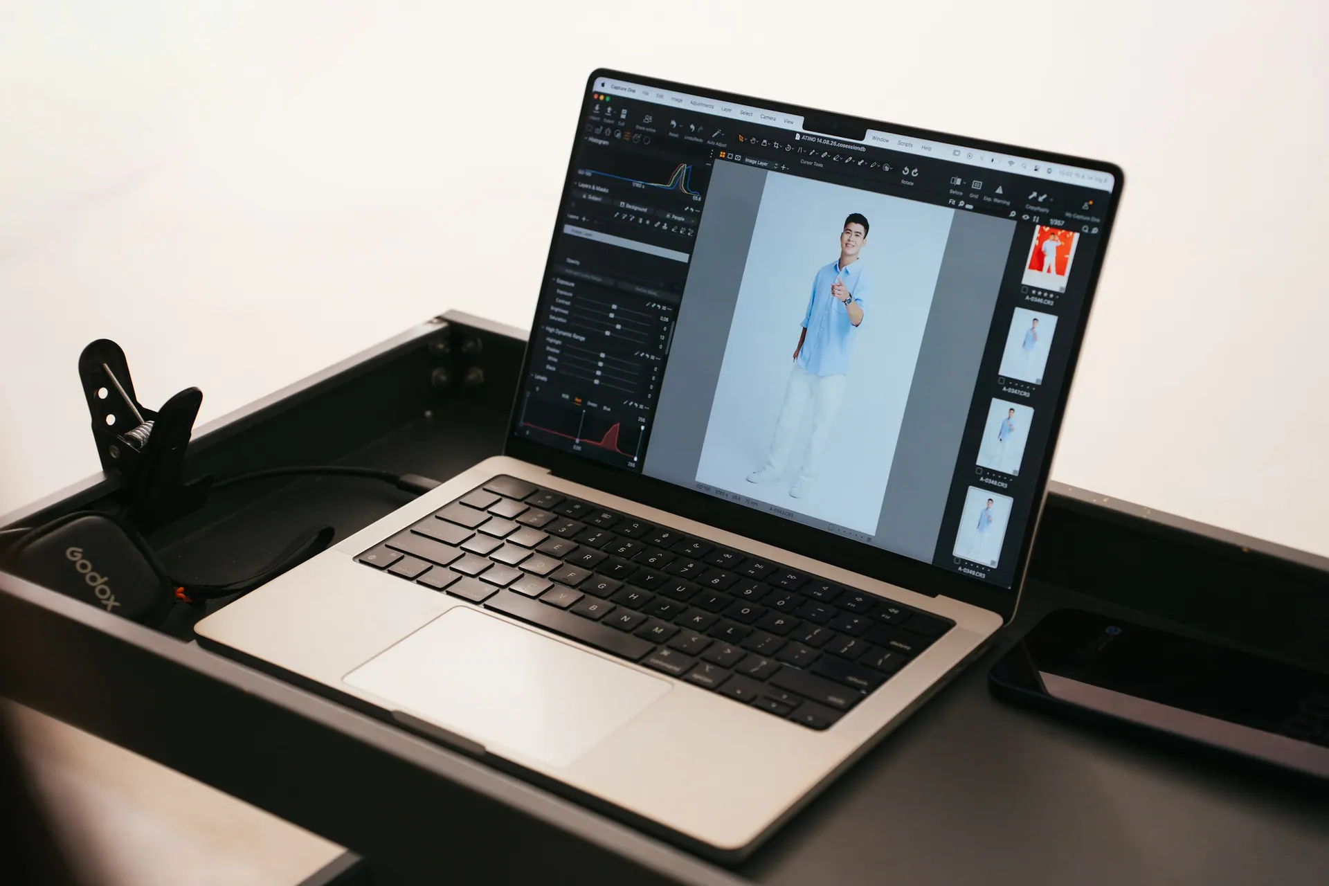 A retouching workspace with a graphics tablet, calibrated monitor and editing software open.