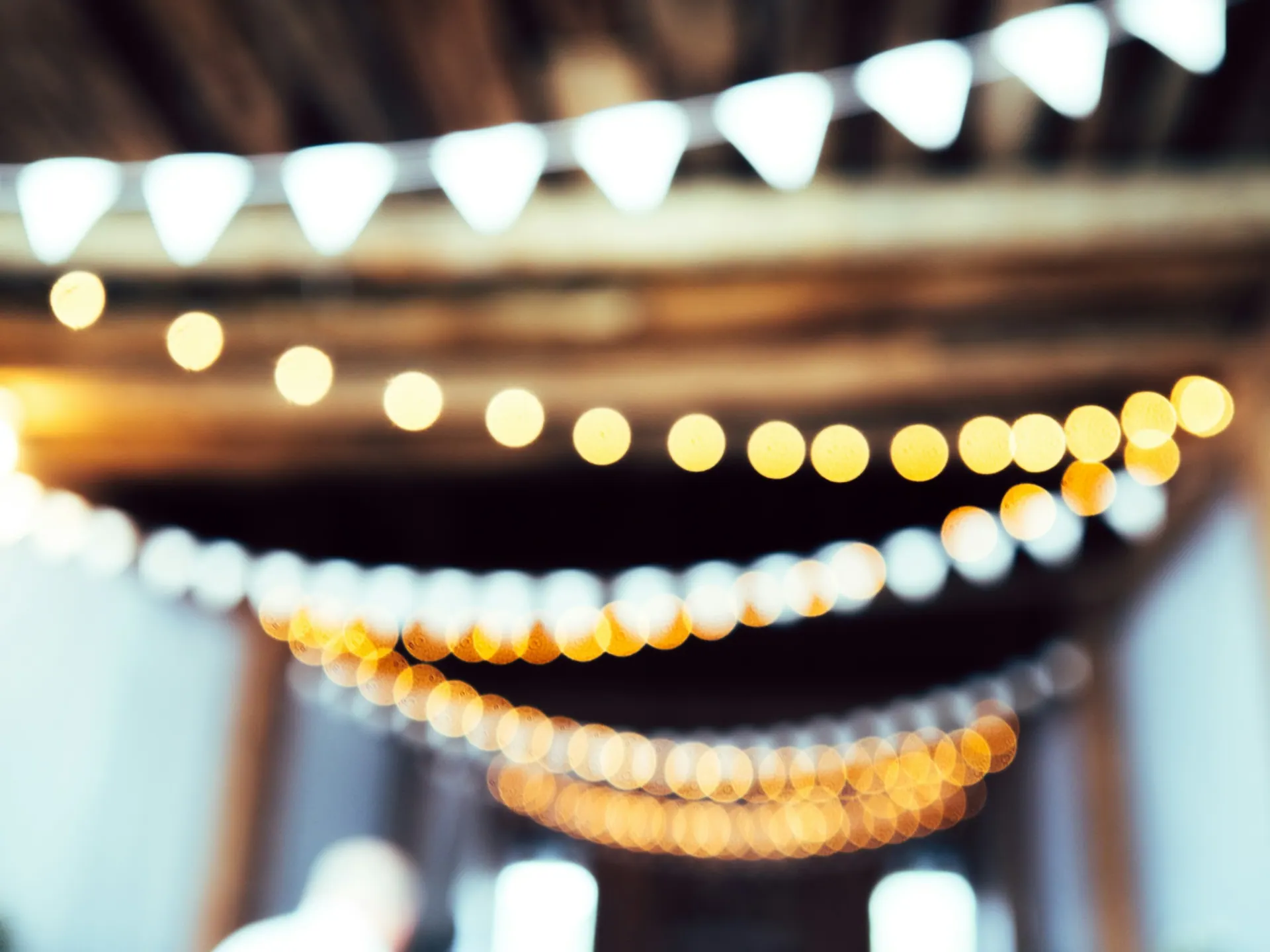Decorative lighting and table settings arranged for a celebration.