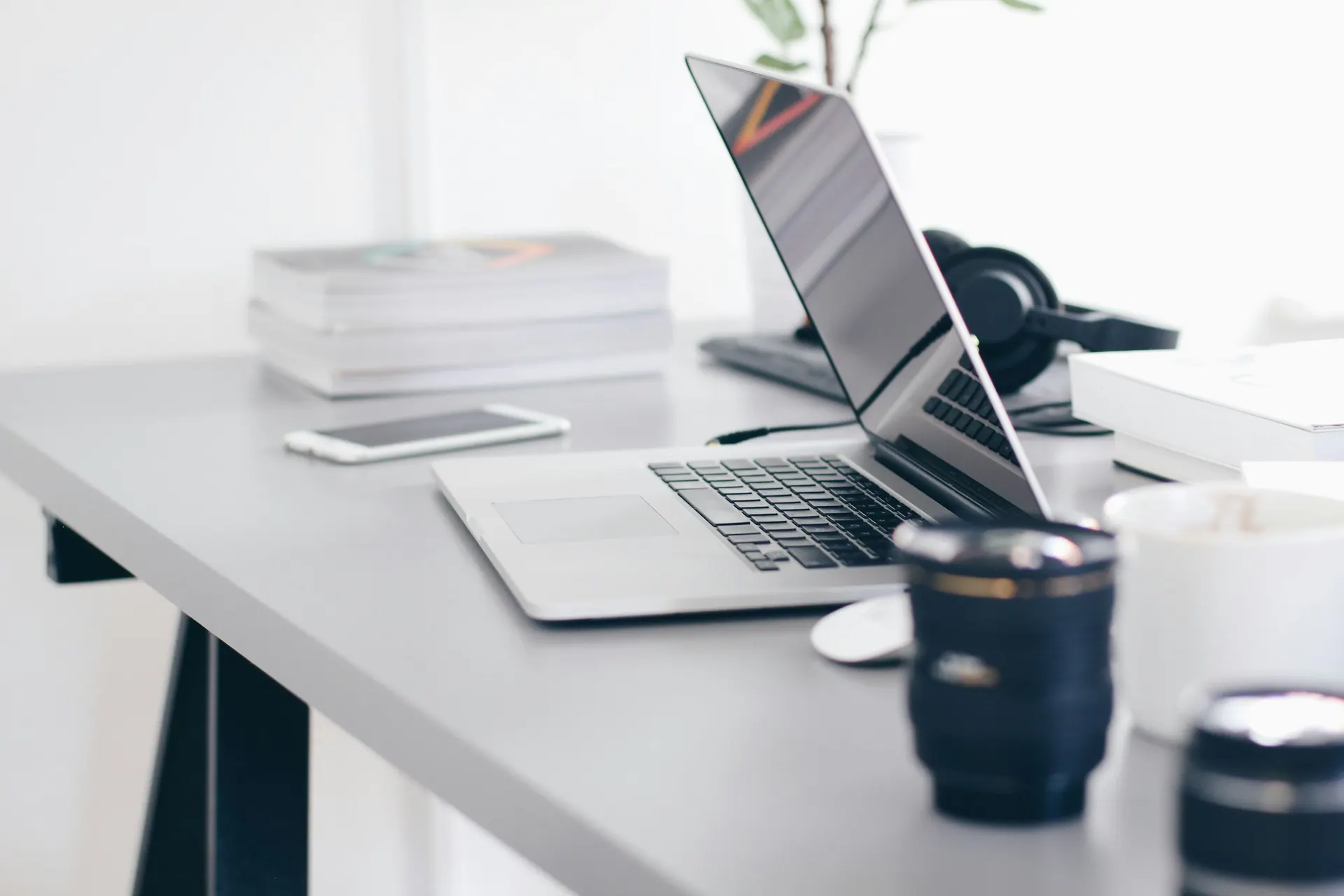 A creative production desk with a schedule, proof prints and camera equipment during project planning.